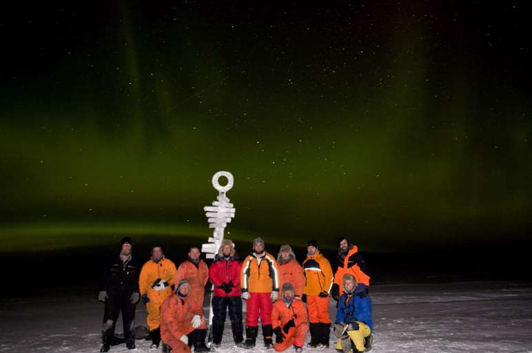 Group in winter with aurora